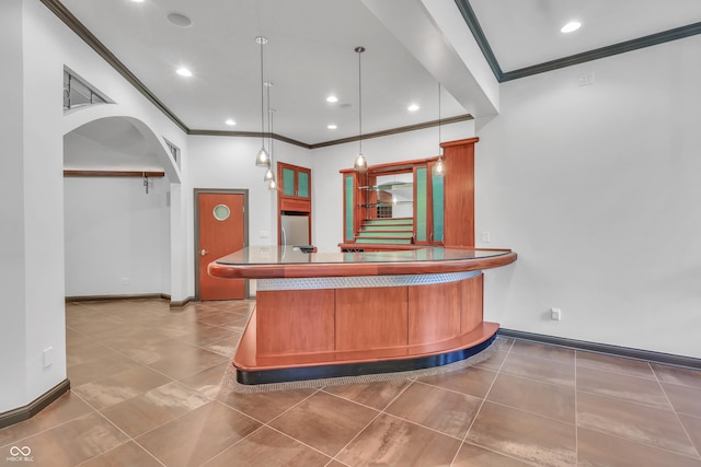 10471 Winghaven Dr, Noblesville, IN 46060 - kitchen with ornamental molding, stainless steel fridge, tile patterned floors, a peninsula, and hanging light fixtures