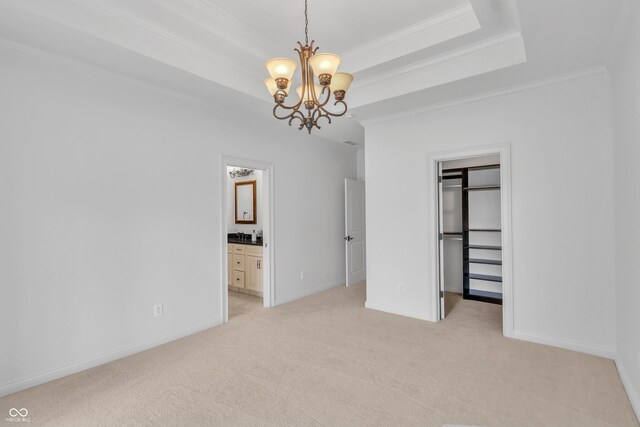 10471 Winghaven Dr, Noblesville, IN 46060 - unfurnished bedroom with a chandelier, light carpet, ornamental molding, a spacious closet, and a tray ceiling