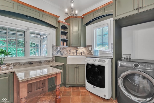 10471 Winghaven Dr, Noblesville, IN 46060 - laundry area featuring washing machine and dryer, cabinet space, ornamental molding, and tile patterned flooring
