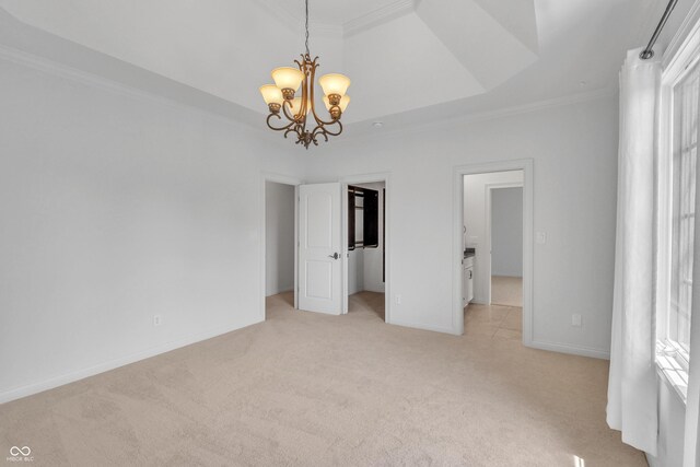 10471 Winghaven Dr, Noblesville, IN 46060 - unfurnished bedroom with light carpet, a chandelier, ornamental molding, a walk in closet, and a tray ceiling