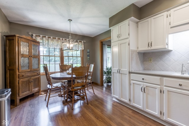 421 Kingsway Ct, Mooresville, IN 46158 - dining area with dark wood-type flooring, a chandelier, and baseboards