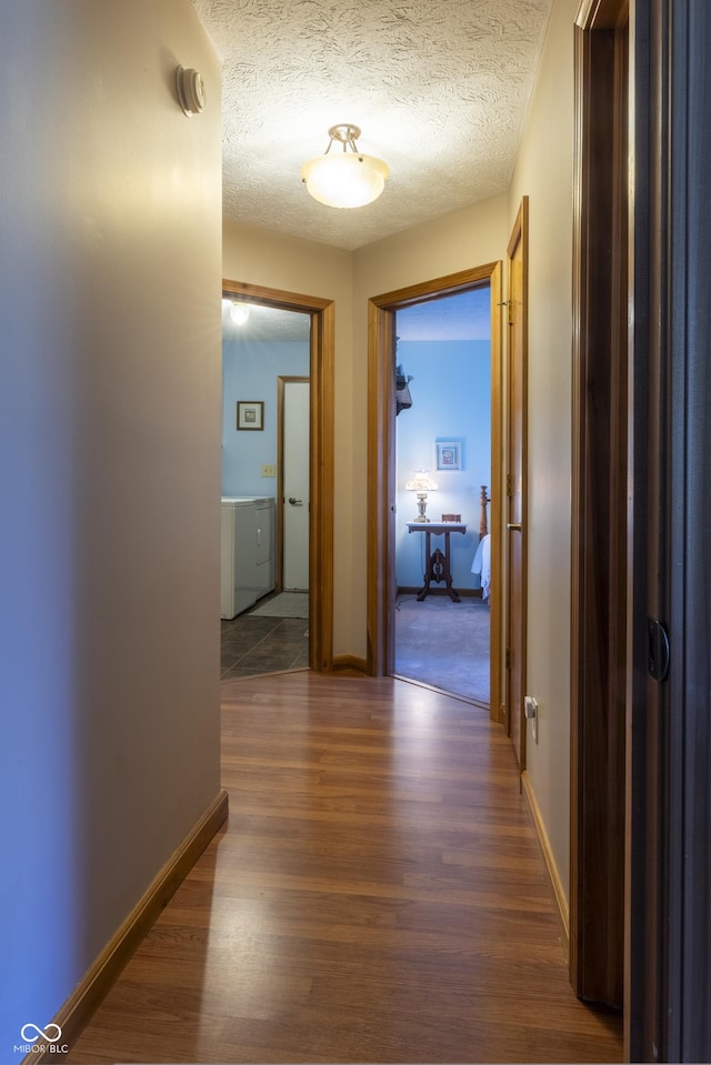 421 Kingsway Ct, Mooresville, IN 46158 - hall with wood finished floors, baseboards, washer / dryer, and a textured ceiling