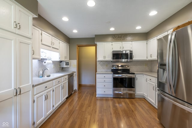 421 Kingsway Ct, Mooresville, IN 46158 - kitchen featuring appliances with stainless steel finishes, light countertops, white cabinetry, a sink, and recessed lighting