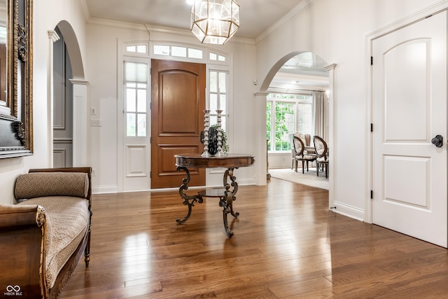 13346 W Sherbern Dr, Carmel, IN 46032 - foyer featuring arched walkways, wood finished floors, and crown molding