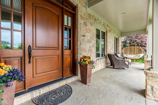 13346 W Sherbern Dr, Carmel, IN 46032 - view of exterior entry with a porch and stone siding