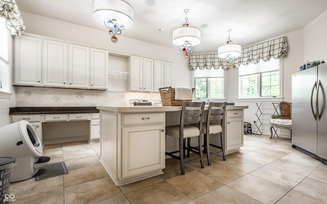 13346 W Sherbern Dr, Carmel, IN 46032 - kitchen featuring freestanding refrigerator, a kitchen island, tasteful backsplash, open shelves, and hanging light fixtures