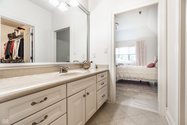 13346 W Sherbern Dr, Carmel, IN 46032 - ensuite bathroom with vanity, tile patterned flooring, and a spacious closet