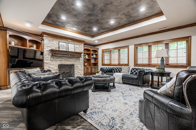 13346 W Sherbern Dr, Carmel, IN 46032 - living area featuring a tray ceiling, ornamental molding, a stone fireplace, and recessed lighting