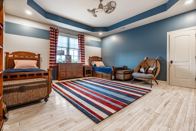 13346 W Sherbern Dr, Carmel, IN 46032 - bedroom with wood finished floors, a tray ceiling, and recessed lighting