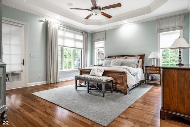 13346 W Sherbern Dr, Carmel, IN 46032 - bedroom with ornamental molding, a tray ceiling, hardwood / wood-style floors, and ceiling fan