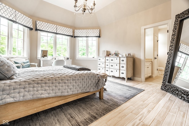 13346 W Sherbern Dr, Carmel, IN 46032 - bedroom featuring a chandelier, wood finished floors, ensuite bathroom, and a towering ceiling