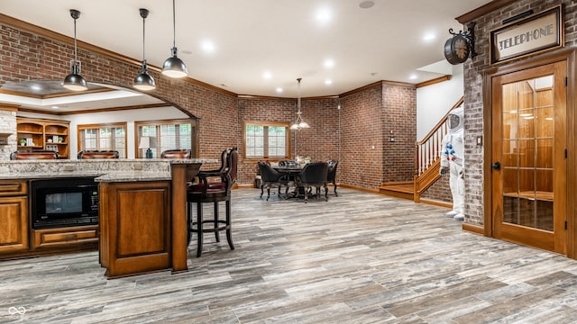 13346 W Sherbern Dr, Carmel, IN 46032 - bar area with black microwave, stairs, ornamental molding, light wood finished floors, and recessed lighting