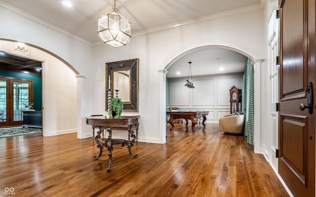 13346 W Sherbern Dr, Carmel, IN 46032 - entryway featuring arched walkways, wood finished floors, crown molding, billiards table, and a decorative wall