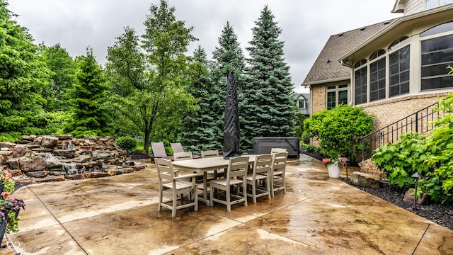 13346 W Sherbern Dr, Carmel, IN 46032 - view of patio / terrace featuring outdoor dining area and a hot tub