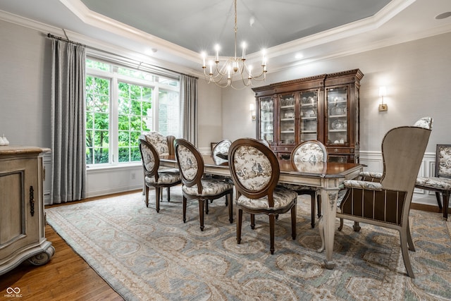 13346 W Sherbern Dr, Carmel, IN 46032 - dining room with a chandelier, a raised ceiling, crown molding, and wood finished floors