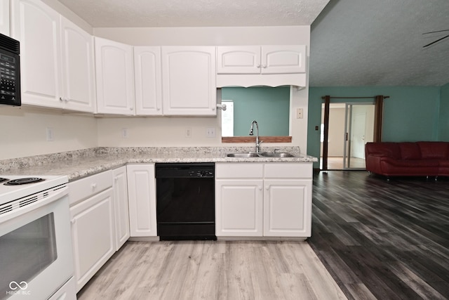 1411 Mimosa Ct, Greenfield, IN 46140 - kitchen with black appliances, light wood-style floors, white cabinets, a textured ceiling, and light countertops