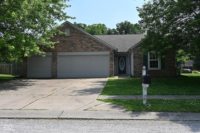 1411 Mimosa Ct, Greenfield, IN 46140 - view of front facade featuring a garage, driveway, brick siding, and a shingled roof