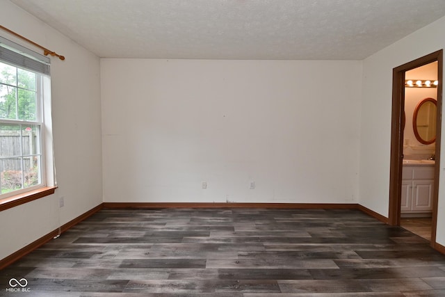 1411 Mimosa Ct, Greenfield, IN 46140 - spare room with dark wood finished floors and a textured ceiling