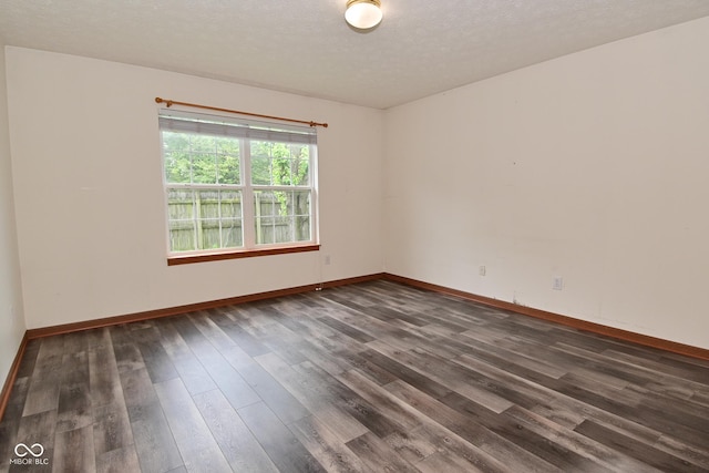 1411 Mimosa Ct, Greenfield, IN 46140 - spare room featuring dark wood-style floors and a textured ceiling