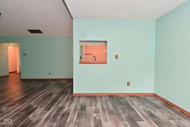 1411 Mimosa Ct, Greenfield, IN 46140 - empty room with a textured ceiling and wood finished floors