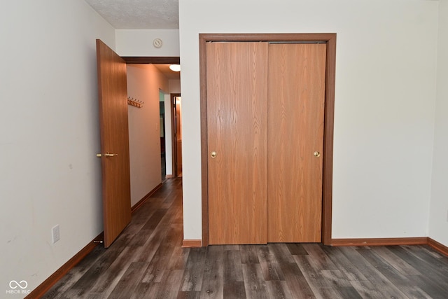 1411 Mimosa Ct, Greenfield, IN 46140 - unfurnished bedroom featuring a closet and dark wood-type flooring
