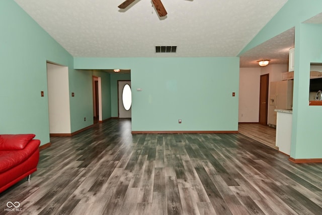 1411 Mimosa Ct, Greenfield, IN 46140 - unfurnished living room featuring a ceiling fan, wood finished floors, vaulted ceiling, and a textured ceiling
