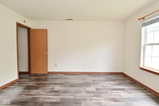 1411 Mimosa Ct, Greenfield, IN 46140 - spare room with wood finished floors and baseboards