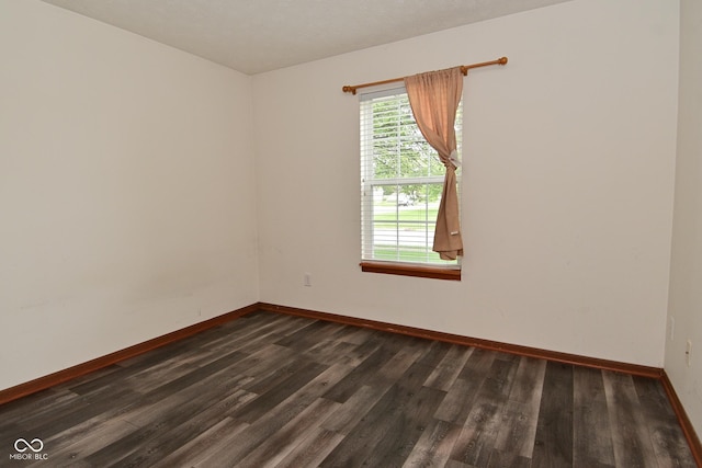 1411 Mimosa Ct, Greenfield, IN 46140 - empty room with dark wood finished floors and baseboards
