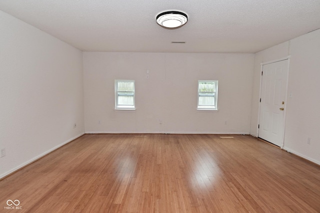 1411 Mimosa Ct, Greenfield, IN 46140 - empty room with healthy amount of natural light and light wood-type flooring