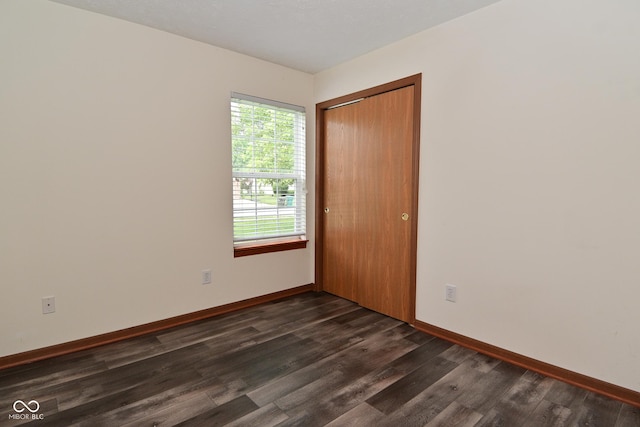 1411 Mimosa Ct, Greenfield, IN 46140 - unfurnished room with dark wood finished floors and baseboards