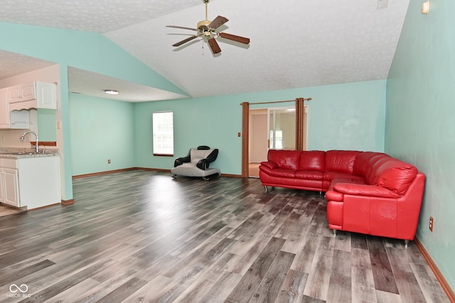 1411 Mimosa Ct, Greenfield, IN 46140 - living area with vaulted ceiling, wood finished floors, ceiling fan, and a textured ceiling