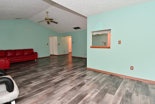 1411 Mimosa Ct, Greenfield, IN 46140 - unfurnished living room featuring a ceiling fan, wood finished floors, lofted ceiling, and a textured ceiling
