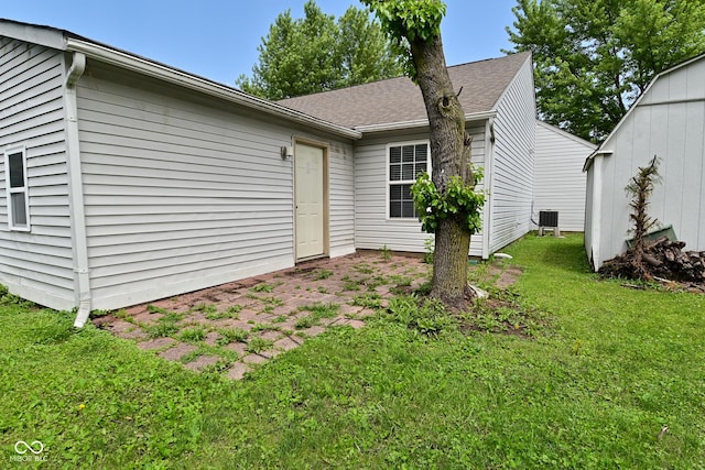 1411 Mimosa Ct, Greenfield, IN 46140 - back of house featuring a lawn and a shingled roof
