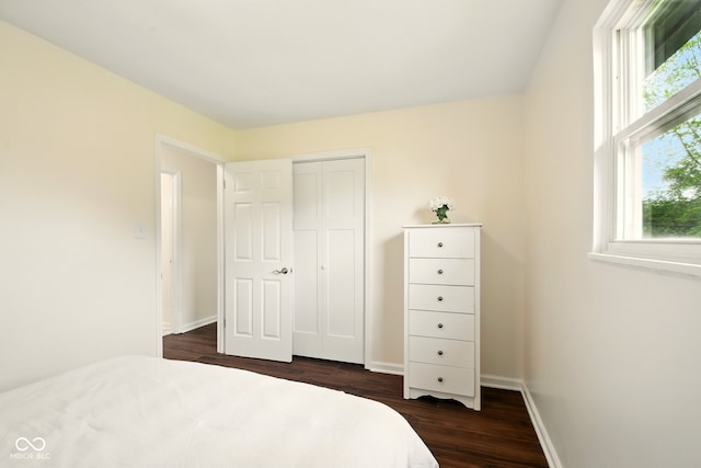 1513 S Rural St, Indianapolis, IN 46203 - bedroom featuring dark wood finished floors, a closet, and baseboards
