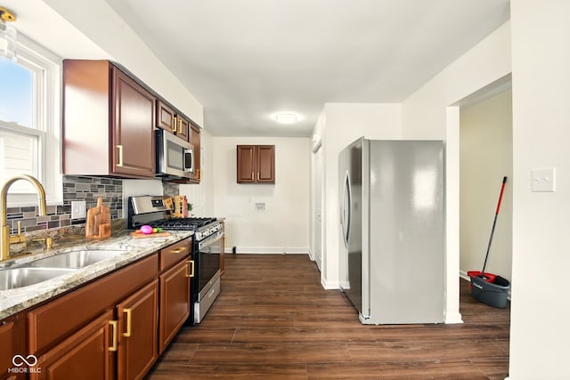 1513 S Rural St, Indianapolis, IN 46203 - kitchen featuring appliances with stainless steel finishes, a sink, light stone counters, and dark wood-type flooring