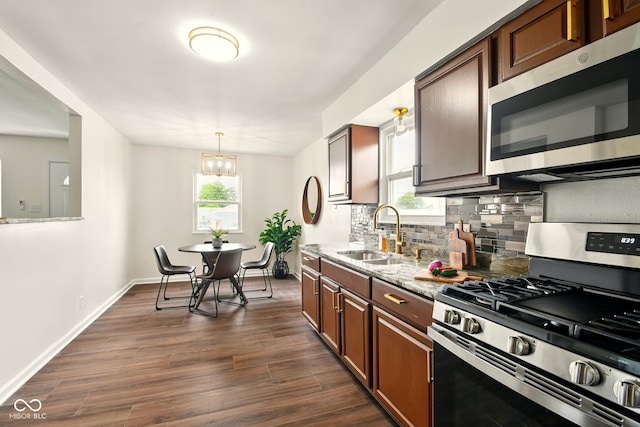 1513 S Rural St, Indianapolis, IN 46203 - kitchen with stainless steel appliances, a sink, decorative backsplash, dark wood-type flooring, and light stone counters
