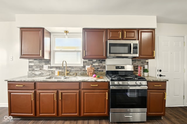 1513 S Rural St, Indianapolis, IN 46203 - kitchen featuring stainless steel appliances, a sink, light stone counters, backsplash, and dark wood-style flooring