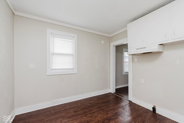 1938 N Dearborn St, Indianapolis, IN 46218 - spare room featuring dark wood finished floors and crown molding