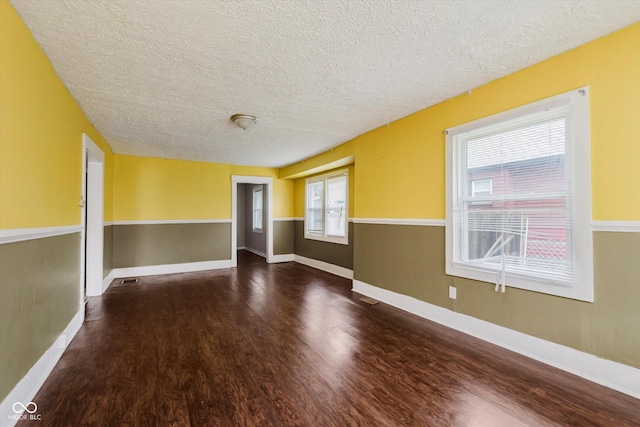 1938 N Dearborn St, Indianapolis, IN 46218 - spare room featuring a textured ceiling and wood finished floors