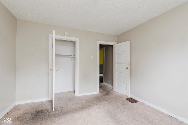 1938 N Dearborn St, Indianapolis, IN 46218 - unfurnished bedroom featuring carpet flooring, a textured ceiling, and a closet