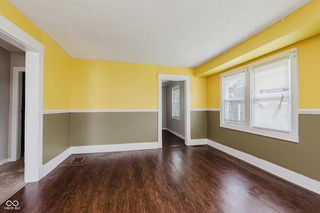 1938 N Dearborn St, Indianapolis, IN 46218 - empty room with wood finished floors and a textured ceiling