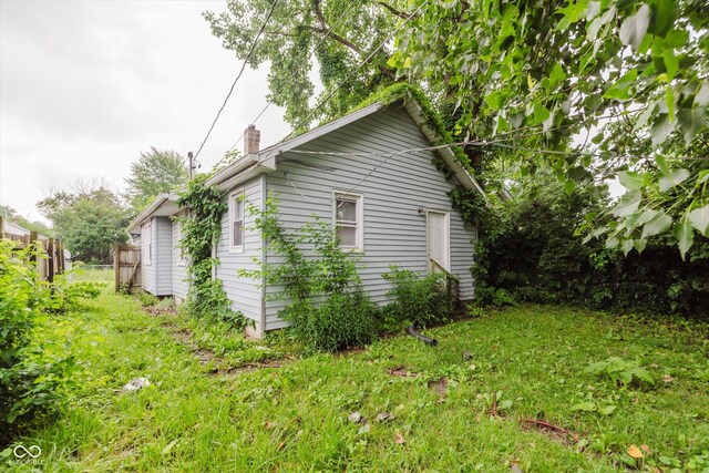 1938 N Dearborn St, Indianapolis, IN 46218 - view of side of property featuring a chimney