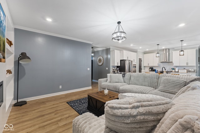 3599 Chalmers Dr, Bargersville, IN 46106 - living room with crown molding, recessed lighting, baseboards, light wood finished floors, and a chandelier