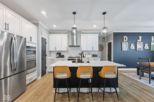 3599 Chalmers Dr, Bargersville, IN 46106 - kitchen with stainless steel appliances, wall chimney exhaust hood, ornamental molding, light wood-style flooring, and light countertops