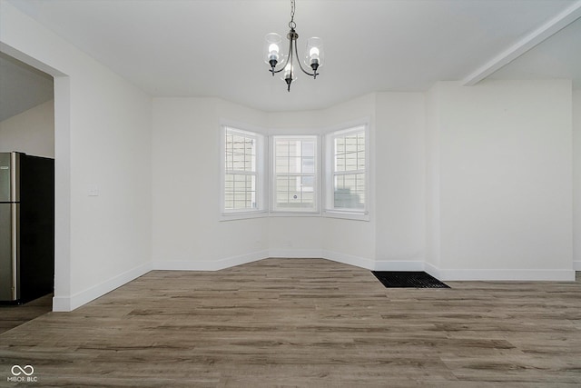 1038 W 33rd St, Indianapolis, IN 46208 - unfurnished dining area with a chandelier and wood finished floors