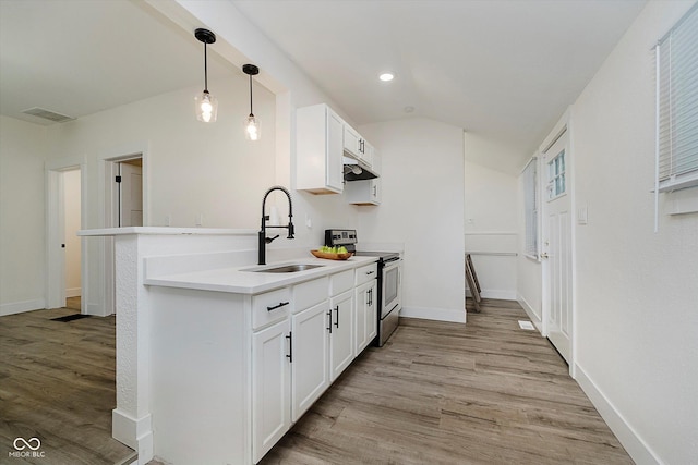 1038 W 33rd St, Indianapolis, IN 46208 - kitchen with stainless steel range with electric stovetop, under cabinet range hood, light wood-style floors, white cabinetry, and recessed lighting
