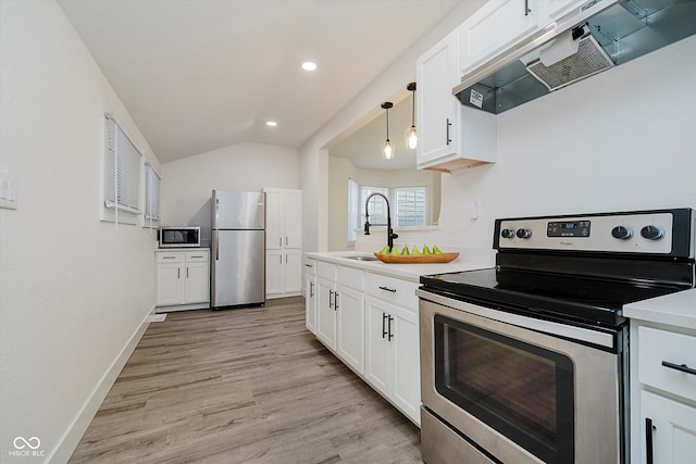 1038 W 33rd St, Indianapolis, IN 46208 - kitchen with appliances with stainless steel finishes, under cabinet range hood, white cabinetry, light countertops, and light wood-style floors