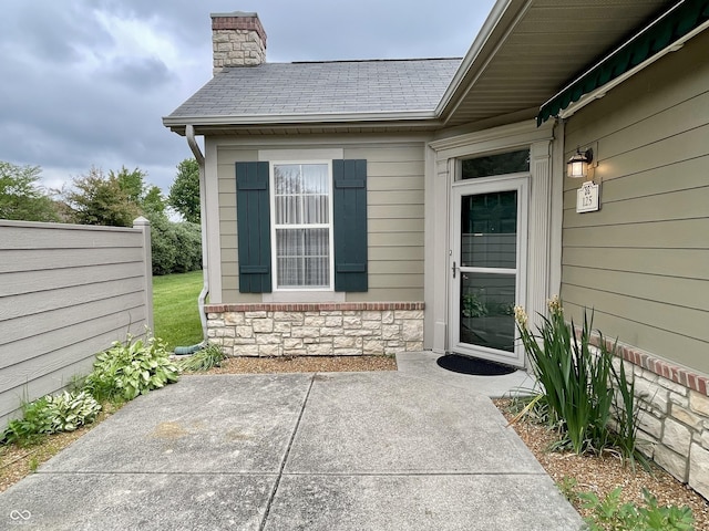 125 Bridgemor Ln, Mooresville, IN 46158 - property entrance with a patio, a chimney, and stone siding