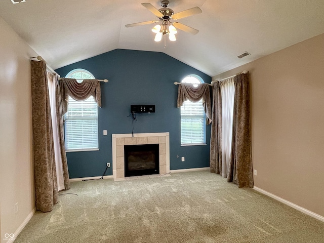 125 Bridgemor Ln, Mooresville, IN 46158 - unfurnished living room with a ceiling fan, a tile fireplace, lofted ceiling, carpet flooring, and plenty of natural light