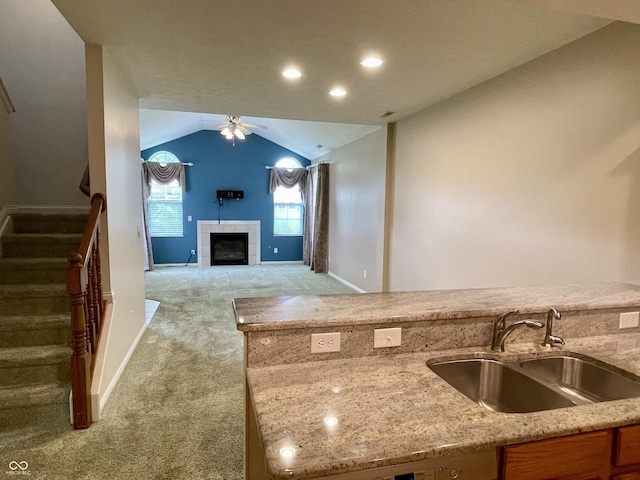 125 Bridgemor Ln, Mooresville, IN 46158 - kitchen with a sink, a ceiling fan, carpet, light stone countertops, and vaulted ceiling